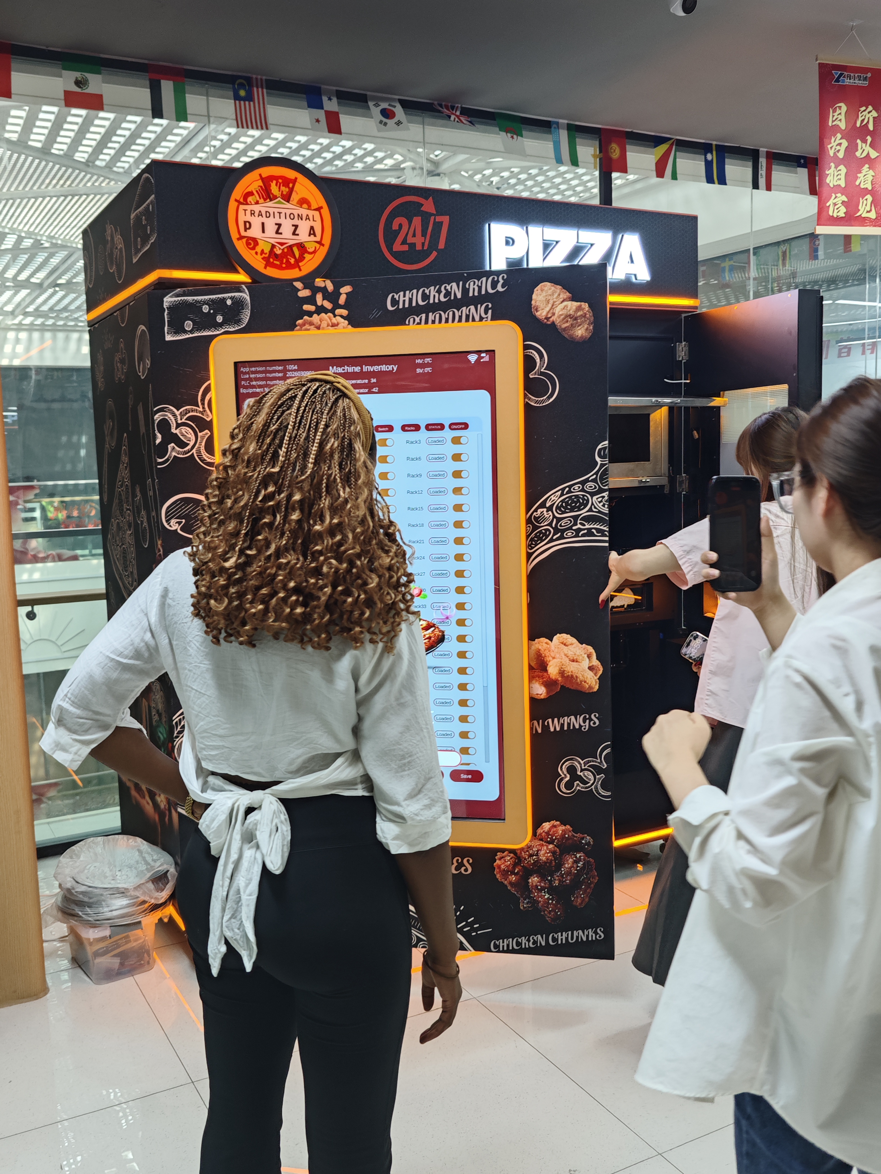 Overseas customer reviewing a vending machine inventory interface during a factory visit